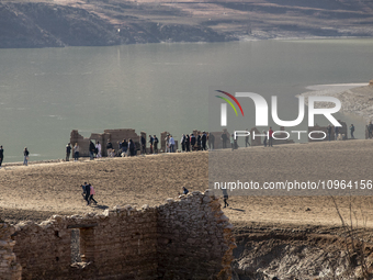 Hundreds of people are visiting the old town of Sant Roma de Sau, where normally the water of the Sau reservoir would almost completely cove...