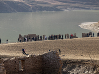 Hundreds of people are visiting the old town of Sant Roma de Sau, where normally the water of the Sau reservoir would almost completely cove...