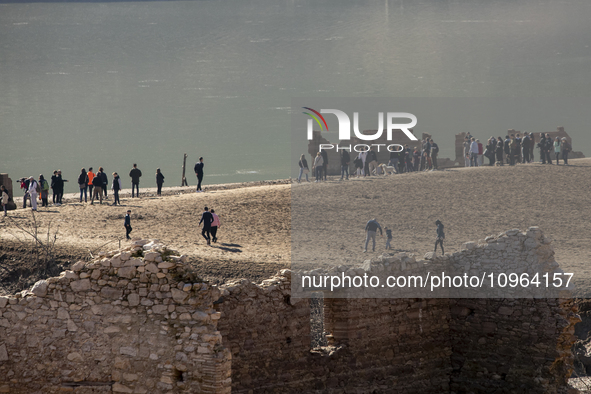 Hundreds of people are visiting the old town of Sant Roma de Sau, where normally the water of the Sau reservoir would almost completely cove...