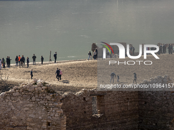 Hundreds of people are visiting the old town of Sant Roma de Sau, where normally the water of the Sau reservoir would almost completely cove...