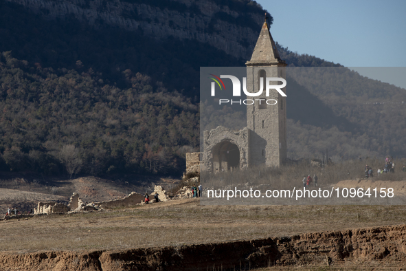 Hundreds of people are visiting the old town of Sant Roma de Sau, where normally the water of the Sau reservoir would almost completely cove...