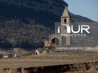 Hundreds of people are visiting the old town of Sant Roma de Sau, where normally the water of the Sau reservoir would almost completely cove...