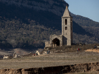 Hundreds of people are visiting the old town of Sant Roma de Sau, where normally the water of the Sau reservoir would almost completely cove...