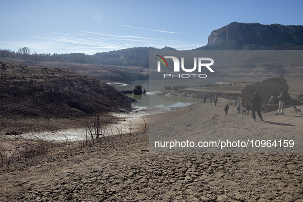 Hundreds of people are visiting the old town of Sant Roma de Sau, where normally the water of the Sau reservoir would almost completely cove...