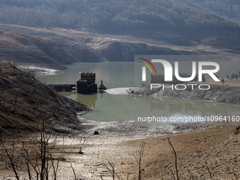 Hundreds of people are visiting the old town of Sant Roma de Sau, where normally the water of the Sau reservoir would almost completely cove...