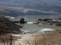 Hundreds of people are visiting the old town of Sant Roma de Sau, where normally the water of the Sau reservoir would almost completely cove...