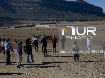 Hundreds of people are visiting the old town of Sant Roma de Sau, where normally the water of the Sau reservoir would almost completely cove...