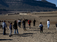 Hundreds of people are visiting the old town of Sant Roma de Sau, where normally the water of the Sau reservoir would almost completely cove...