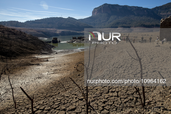 Hundreds of people are visiting the old town of Sant Roma de Sau, where normally the water of the Sau reservoir would almost completely cove...