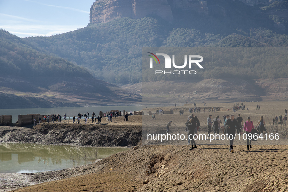 Hundreds of people are visiting the old town of Sant Roma de Sau, where normally the water of the Sau reservoir would almost completely cove...