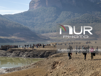 Hundreds of people are visiting the old town of Sant Roma de Sau, where normally the water of the Sau reservoir would almost completely cove...