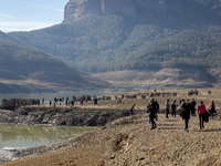 Hundreds of people are visiting the old town of Sant Roma de Sau, where normally the water of the Sau reservoir would almost completely cove...