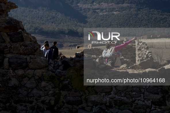 Hundreds of people are visiting the old town of Sant Roma de Sau, where normally the water of the Sau reservoir would almost completely cove...