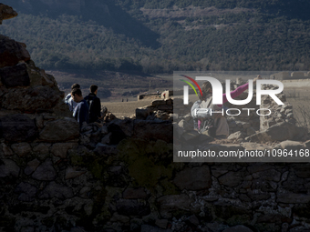 Hundreds of people are visiting the old town of Sant Roma de Sau, where normally the water of the Sau reservoir would almost completely cove...