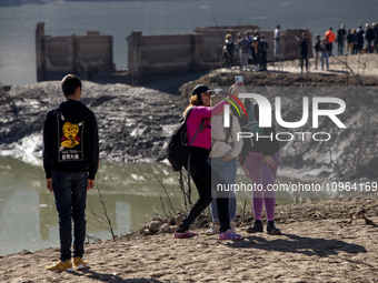 Hundreds of people are visiting the old town of Sant Roma de Sau, where normally the water of the Sau reservoir would almost completely cove...