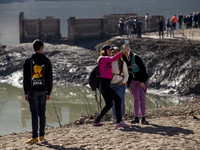 Hundreds of people are visiting the old town of Sant Roma de Sau, where normally the water of the Sau reservoir would almost completely cove...