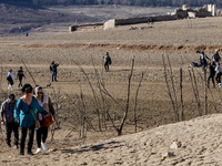 Hundreds of people are visiting the old town of Sant Roma de Sau, where normally the water of the Sau reservoir would almost completely cove...