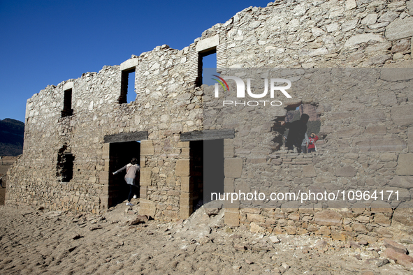 Hundreds of people are visiting the old town of Sant Roma de Sau, where normally the water of the Sau reservoir would almost completely cove...