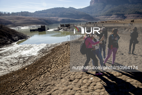 Hundreds of people are visiting the old town of Sant Roma de Sau, where normally the water of the Sau reservoir would almost completely cove...