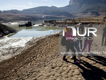 Hundreds of people are visiting the old town of Sant Roma de Sau, where normally the water of the Sau reservoir would almost completely cove...