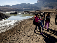 Hundreds of people are visiting the old town of Sant Roma de Sau, where normally the water of the Sau reservoir would almost completely cove...