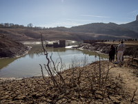 Hundreds of people are visiting the old town of Sant Roma de Sau, where normally the water of the Sau reservoir would almost completely cove...