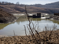 Hundreds of people are visiting the old town of Sant Roma de Sau, where normally the water of the Sau reservoir would almost completely cove...