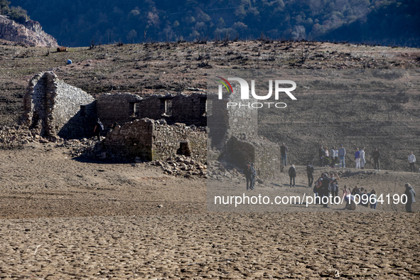 Hundreds of people are visiting the old town of Sant Roma de Sau, where normally the water of the Sau reservoir would almost completely cove...