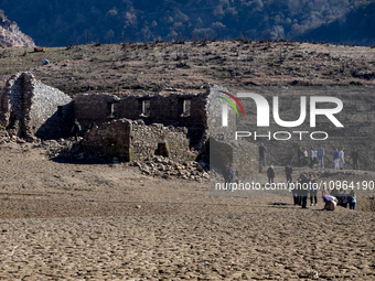 Hundreds of people are visiting the old town of Sant Roma de Sau, where normally the water of the Sau reservoir would almost completely cove...