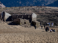 Hundreds of people are visiting the old town of Sant Roma de Sau, where normally the water of the Sau reservoir would almost completely cove...