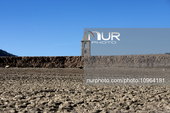 Hundreds of people are visiting the old town of Sant Roma de Sau, where normally the water of the Sau reservoir would almost completely cove...