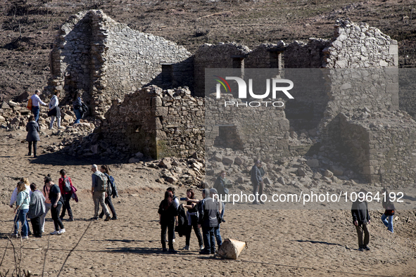 Hundreds of people are visiting the old town of Sant Roma de Sau, where normally the water of the Sau reservoir would almost completely cove...