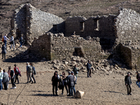 Hundreds of people are visiting the old town of Sant Roma de Sau, where normally the water of the Sau reservoir would almost completely cove...