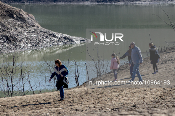 Hundreds of people are visiting the old town of Sant Roma de Sau, where normally the water of the Sau reservoir would almost completely cove...