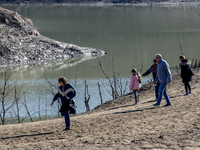 Hundreds of people are visiting the old town of Sant Roma de Sau, where normally the water of the Sau reservoir would almost completely cove...