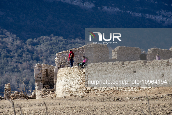 Hundreds of people are visiting the old town of Sant Roma de Sau, where normally the water of the Sau reservoir would almost completely cove...