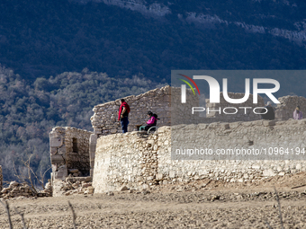 Hundreds of people are visiting the old town of Sant Roma de Sau, where normally the water of the Sau reservoir would almost completely cove...