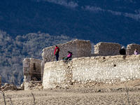 Hundreds of people are visiting the old town of Sant Roma de Sau, where normally the water of the Sau reservoir would almost completely cove...