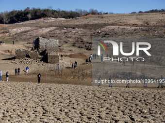 Hundreds of people are visiting the old town of Sant Roma de Sau, where normally the water of the Sau reservoir would almost completely cove...