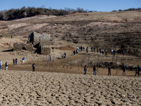 Hundreds of people are visiting the old town of Sant Roma de Sau, where normally the water of the Sau reservoir would almost completely cove...