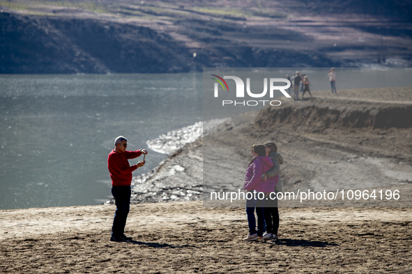 Hundreds of people are visiting the old town of Sant Roma de Sau, where normally the water of the Sau reservoir would almost completely cove...