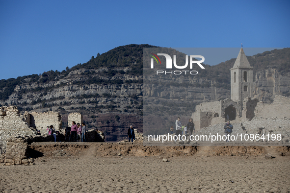 Hundreds of people are visiting the old town of Sant Roma de Sau, where normally the water of the Sau reservoir would almost completely cove...