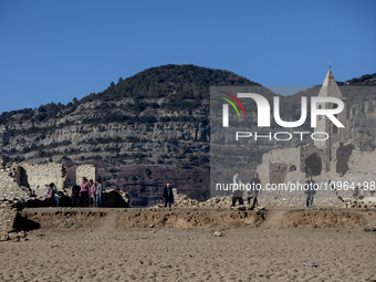 Hundreds of people are visiting the old town of Sant Roma de Sau, where normally the water of the Sau reservoir would almost completely cove...