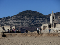 Hundreds of people are visiting the old town of Sant Roma de Sau, where normally the water of the Sau reservoir would almost completely cove...