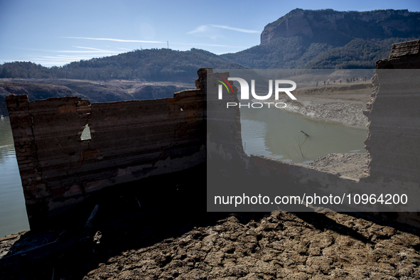 Hundreds of people are visiting the old town of Sant Roma de Sau, where normally the water of the Sau reservoir would almost completely cove...