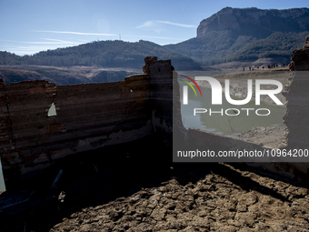 Hundreds of people are visiting the old town of Sant Roma de Sau, where normally the water of the Sau reservoir would almost completely cove...