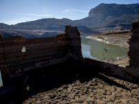 Hundreds of people are visiting the old town of Sant Roma de Sau, where normally the water of the Sau reservoir would almost completely cove...