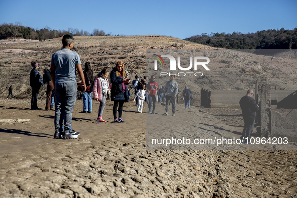 Hundreds of people are visiting the old town of Sant Roma de Sau, where normally the water of the Sau reservoir would almost completely cove...