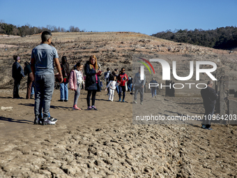 Hundreds of people are visiting the old town of Sant Roma de Sau, where normally the water of the Sau reservoir would almost completely cove...