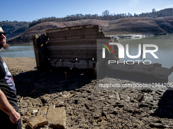 Hundreds of people are visiting the old town of Sant Roma de Sau, where normally the water of the Sau reservoir would almost completely cove...